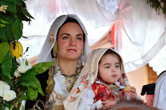 a woman and a little girl dressed in traditional clothing