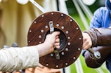 a person holding a sword with another person's hand