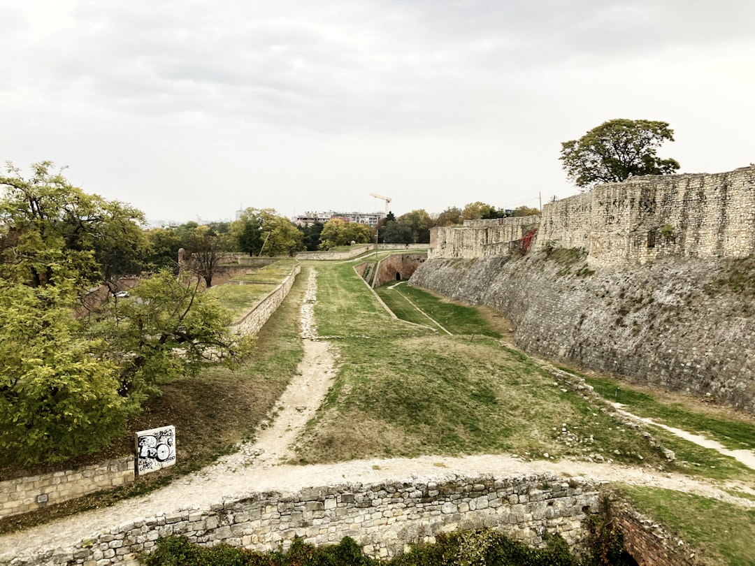a stone wall with a sign on the side of it,