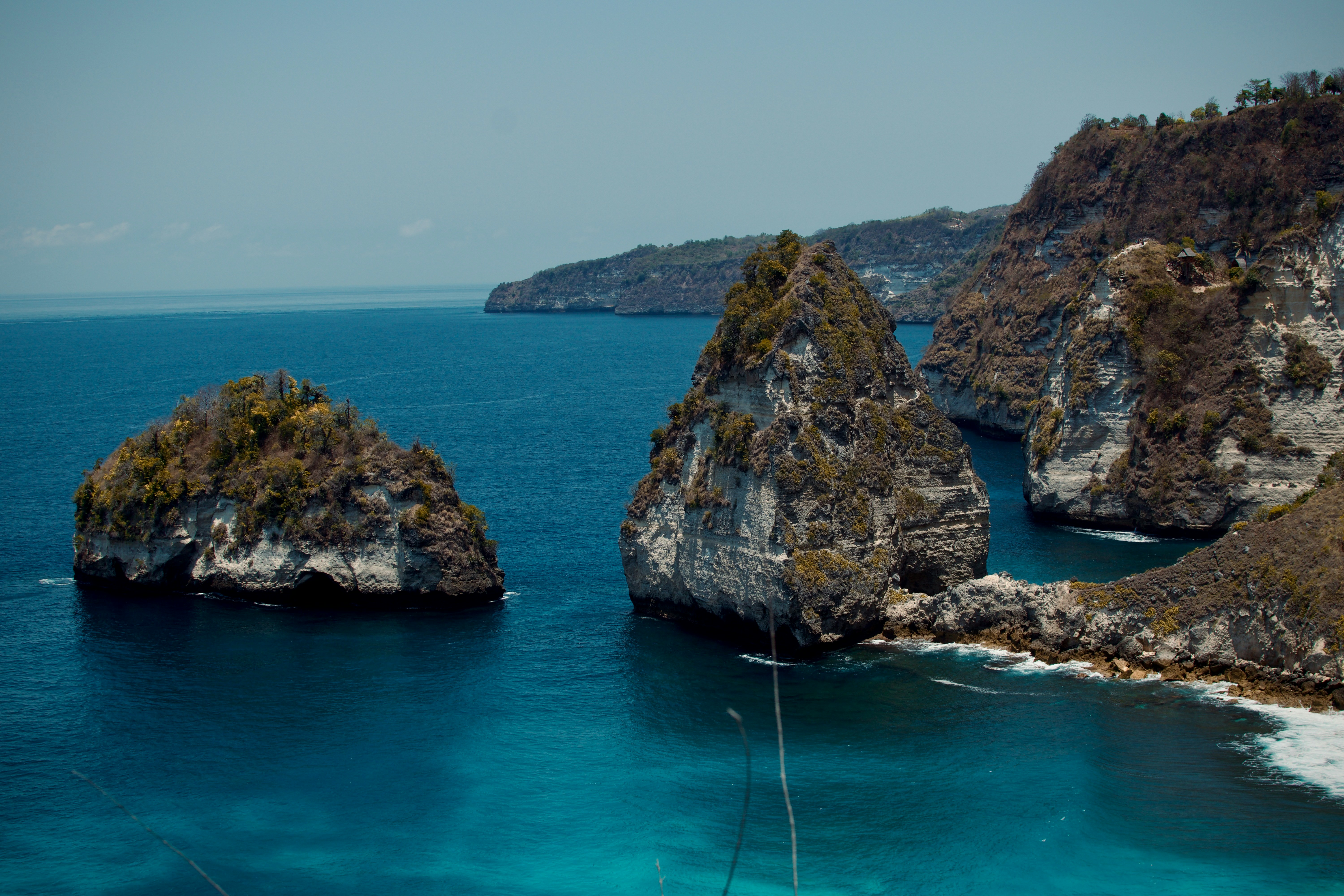 a couple of large rocks in the middle of a body of water