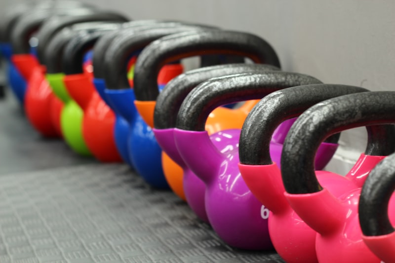 Kettlebells seřazené u zdi v tělocvičně
