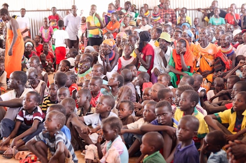 a large group of people sitting on the ground