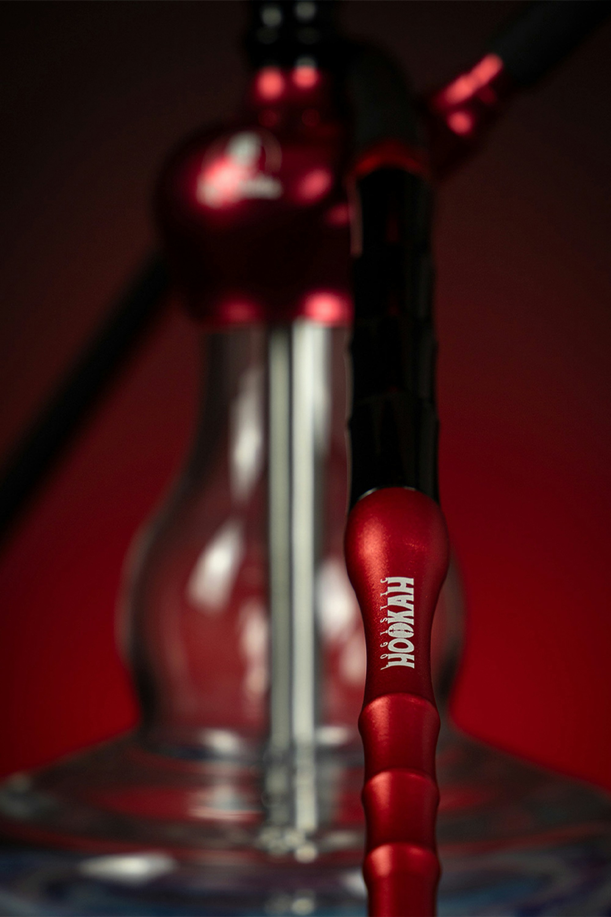 a close up of a red object with a black handle