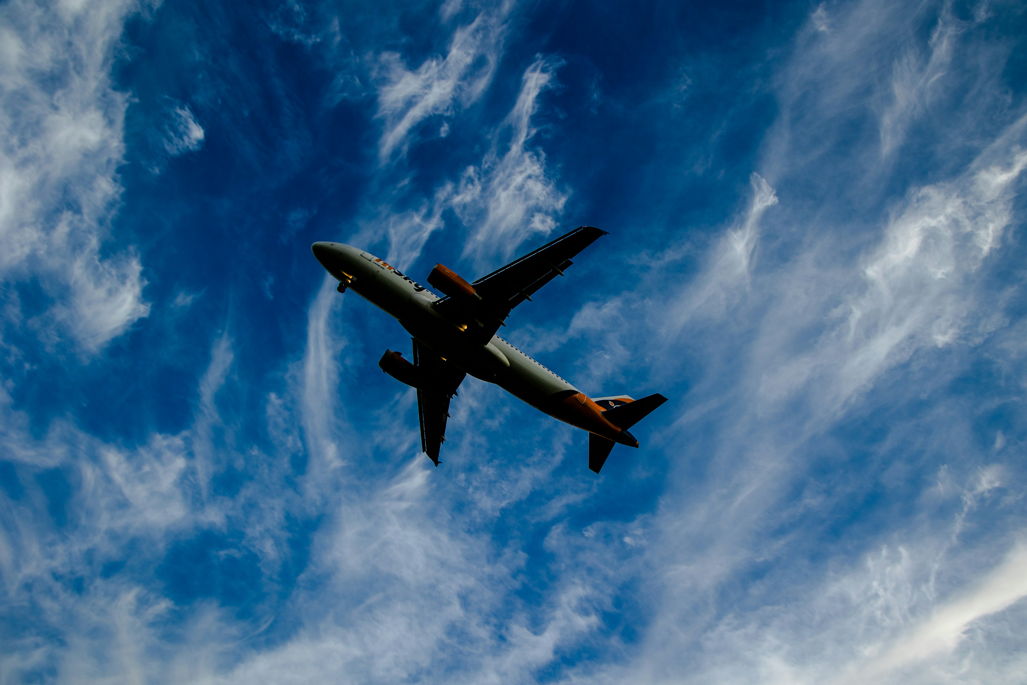 an airplane is flying through the blue sky