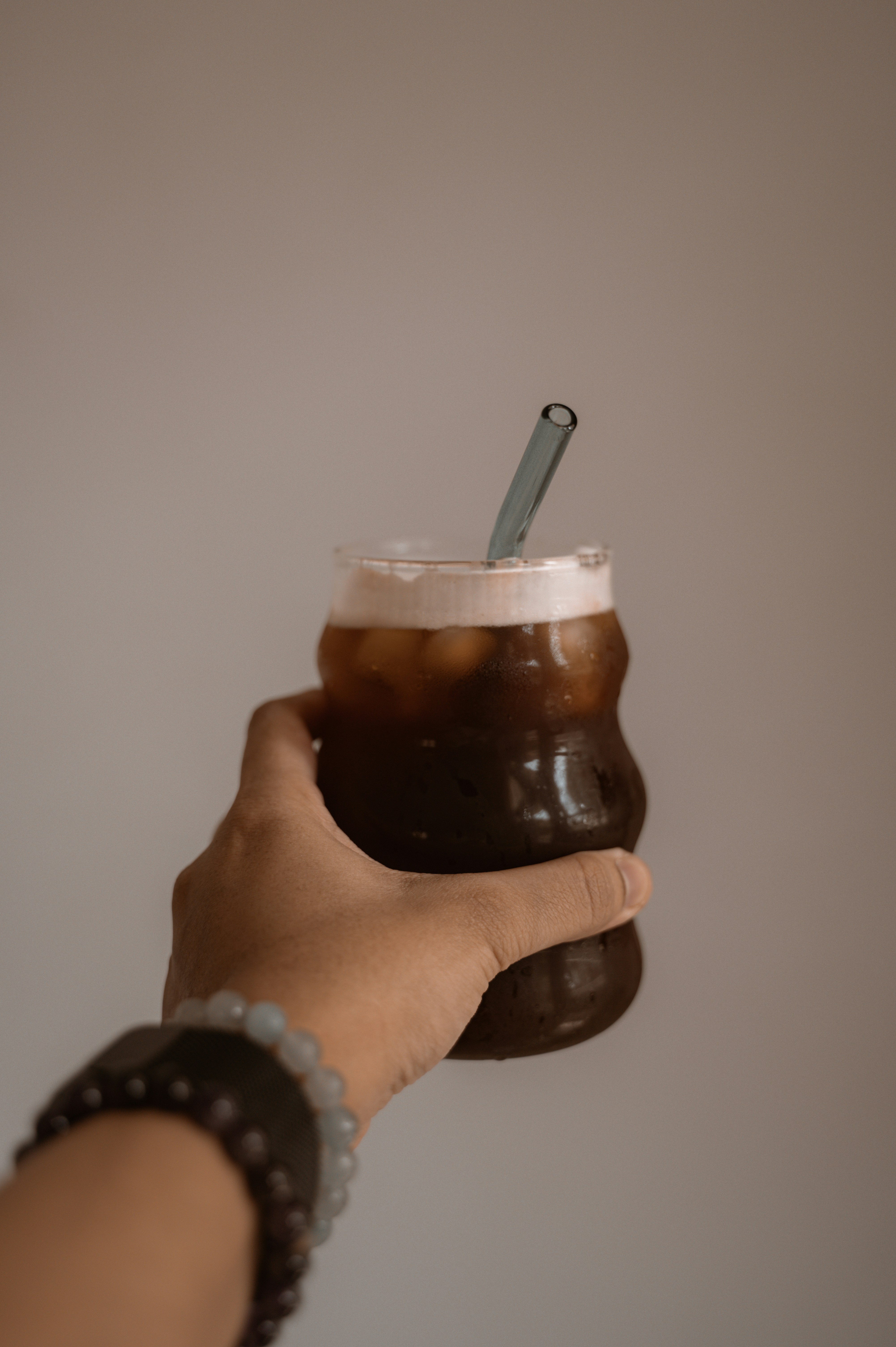 a person holding a cup with a straw in it