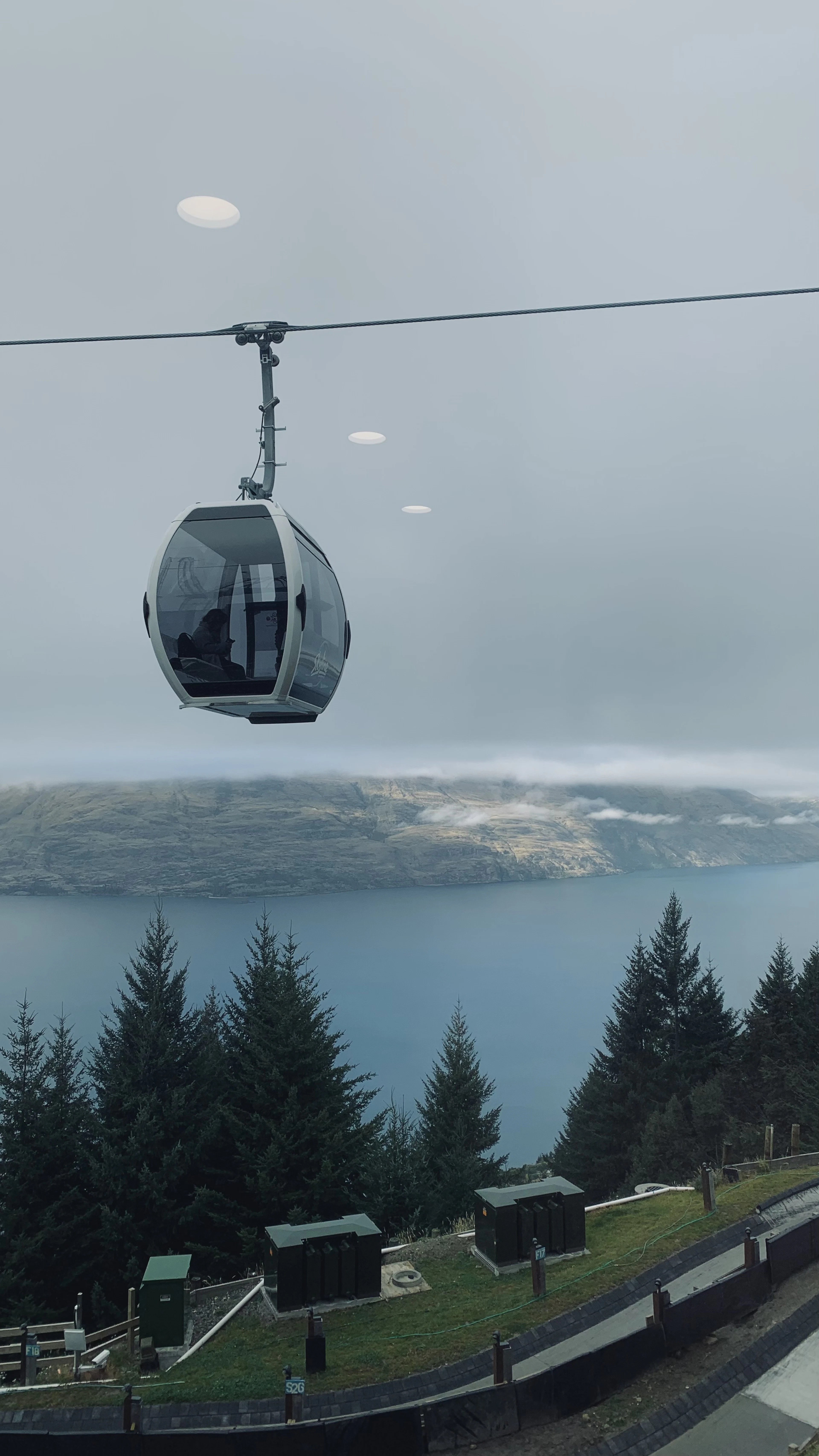 A gondola cabin ascending Bob's Peak above Lake Wakatipu in Queenstown