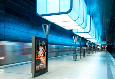 a subway station with a train passing by