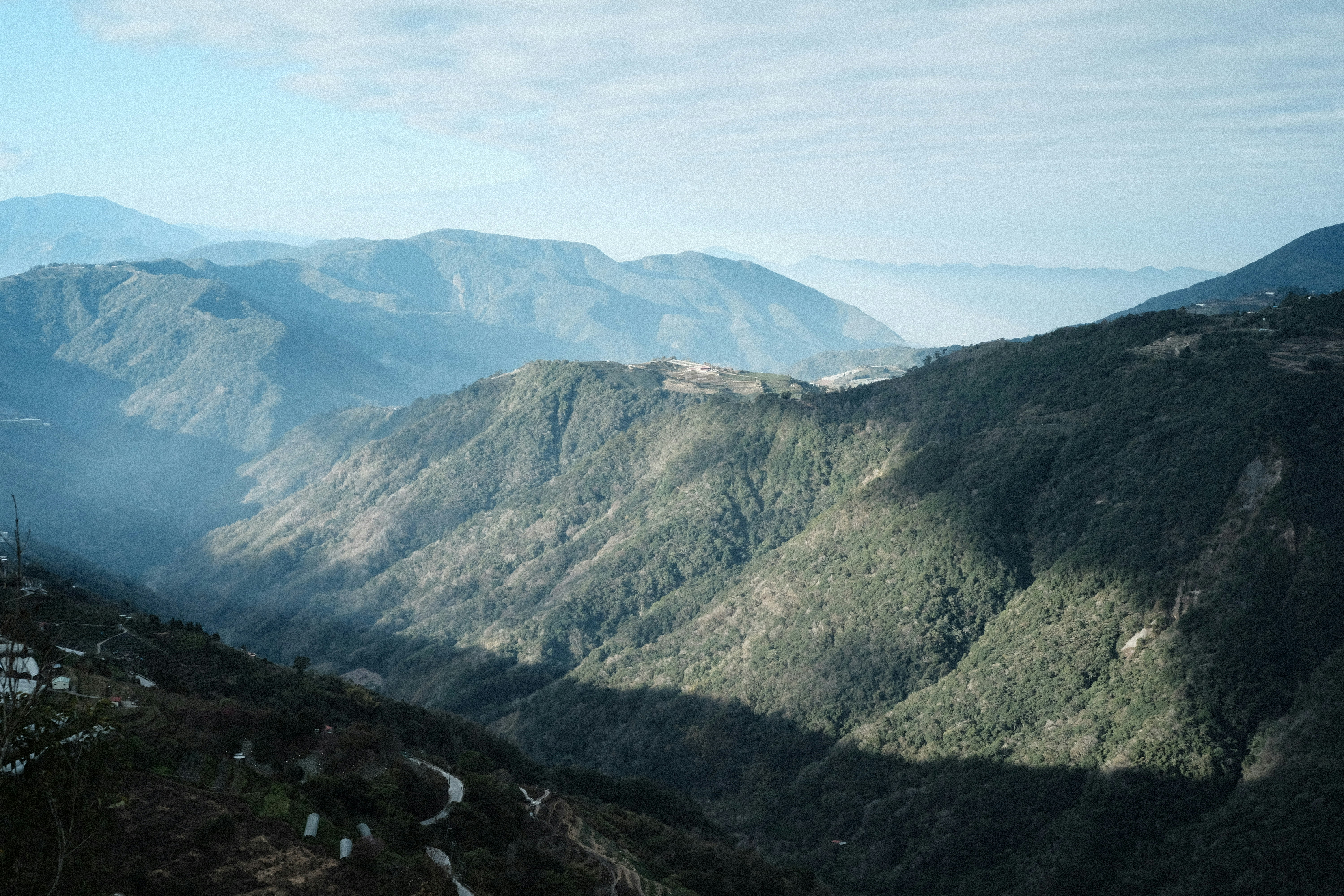 a view of a valley with mountains in the background