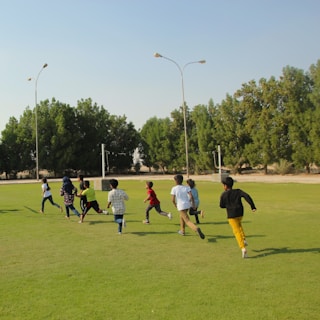 a group of young children playing a game of soccer