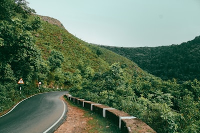 a winding road surrounded by lush green hills