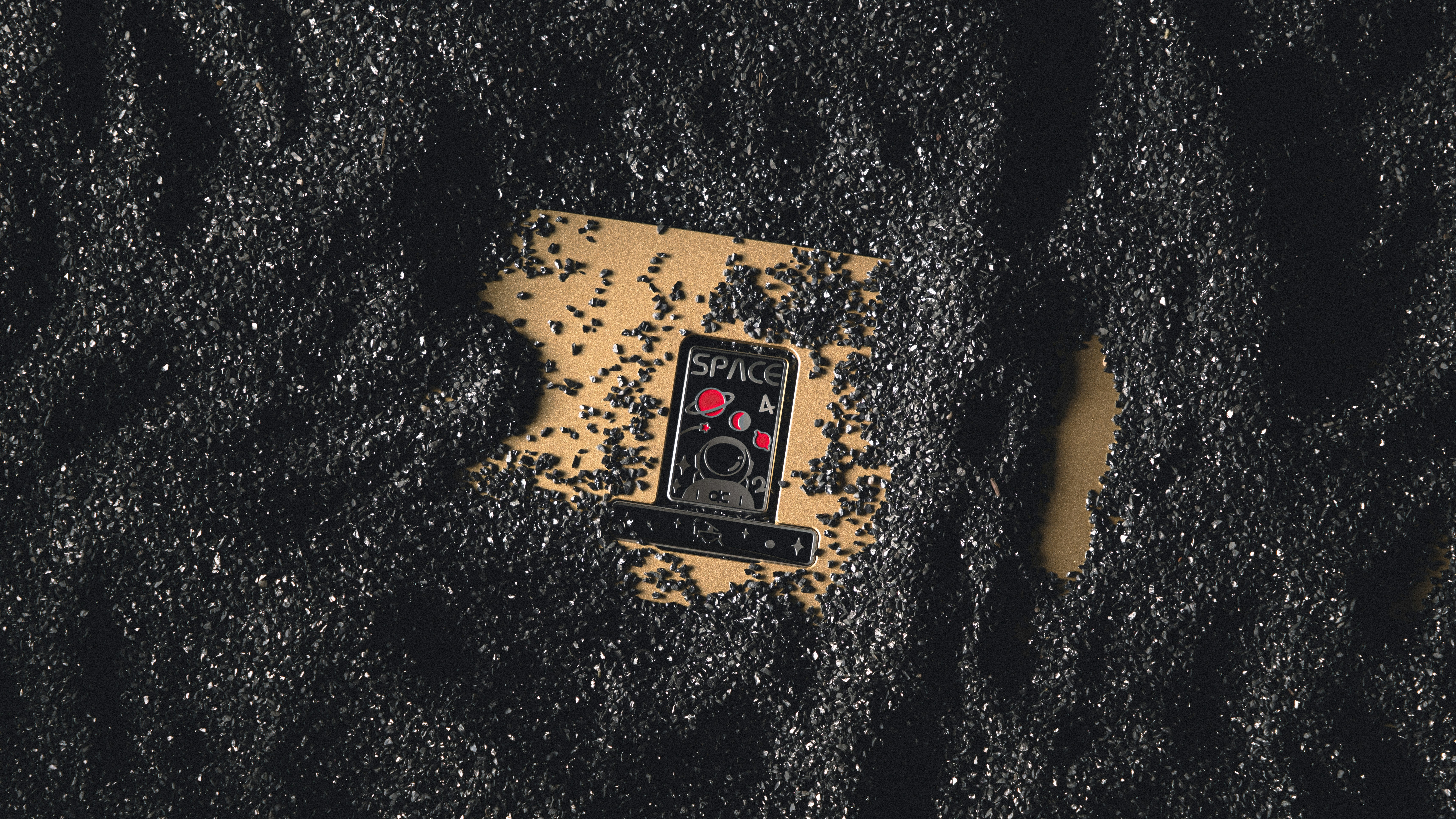 a cell phone laying on top of a black surface