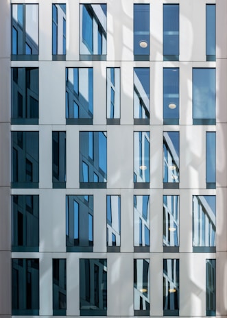 a tall building with lots of windows next to a street
