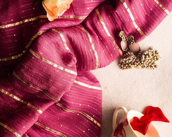 a close up of a scarf with a flower on it