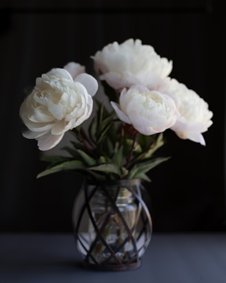 a vase filled with white flowers on top of a table