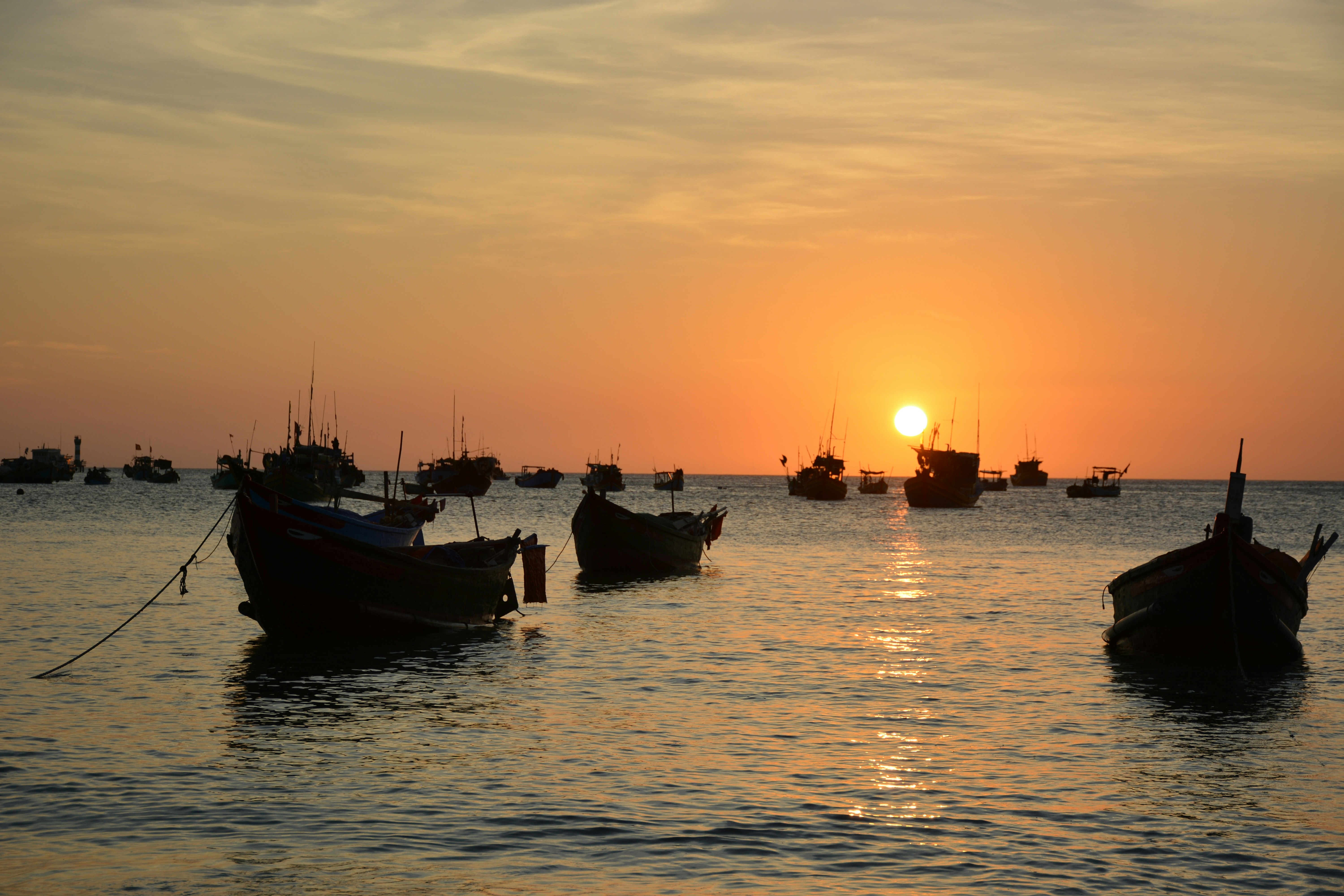a group of boats floating on top of a body of water