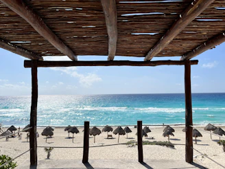 a view of a beach with umbrellas and the ocean
