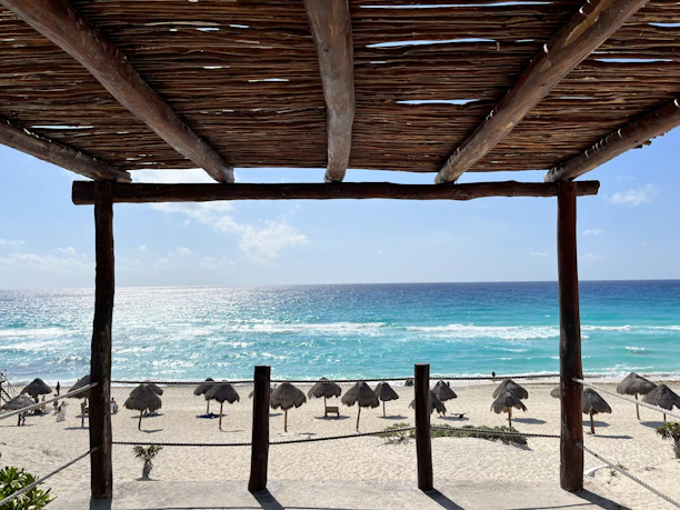 a view of a beach with umbrellas and the ocean