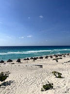 a bunch of umbrellas that are on a beach