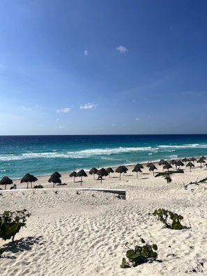 a bunch of umbrellas that are on a beach