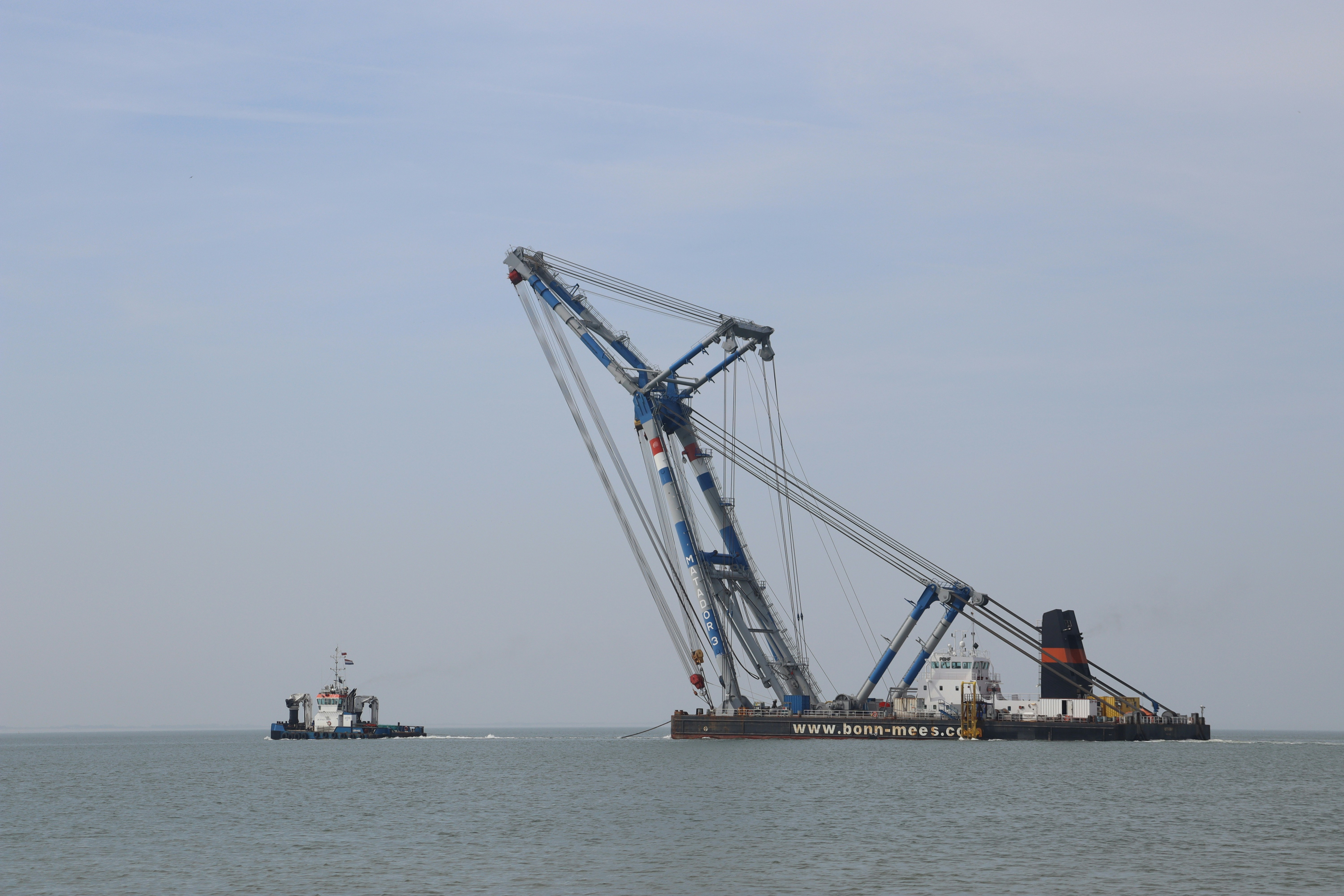 a large crane sitting on top of a body of water