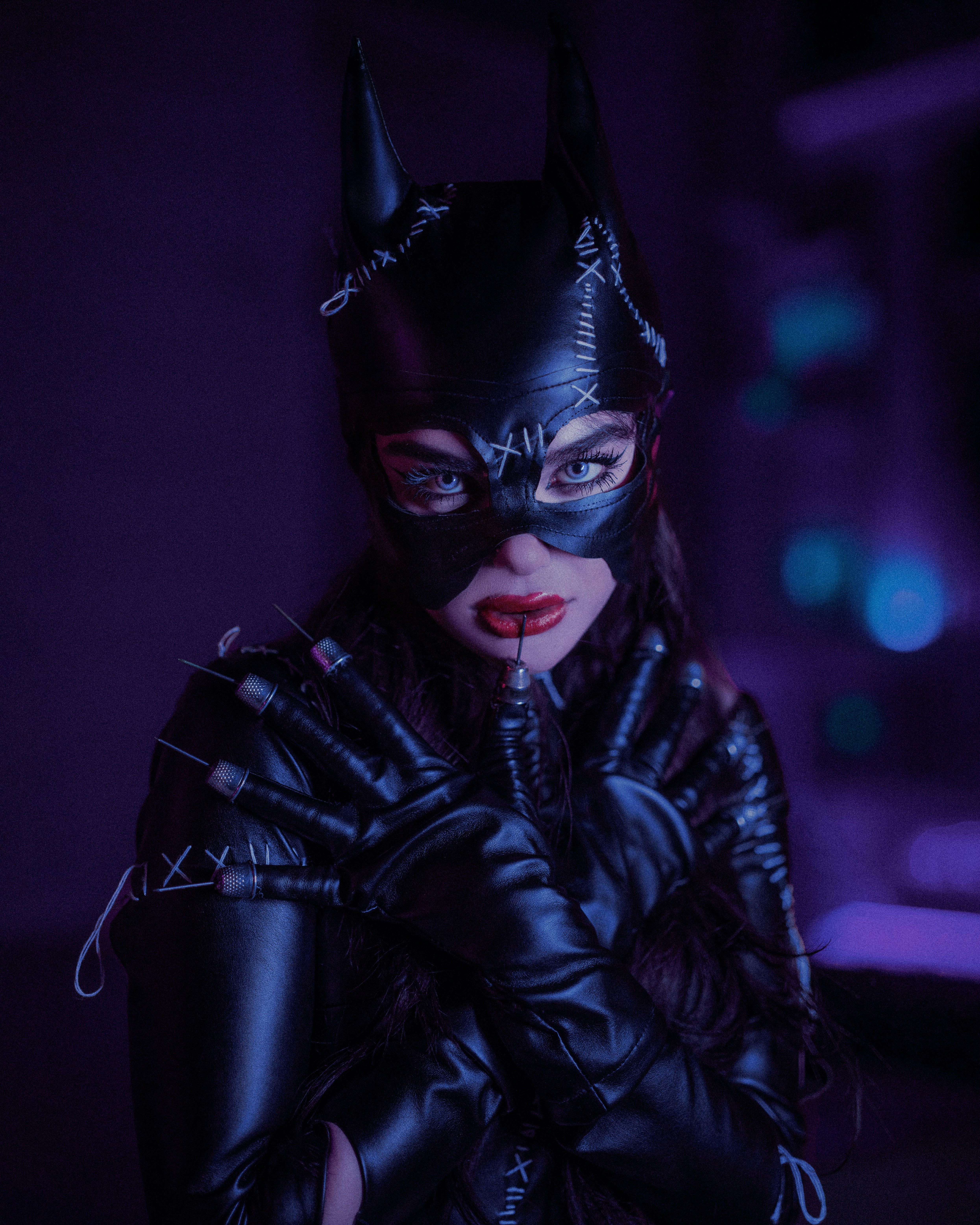 a woman wearing a catwoman mask and gloves