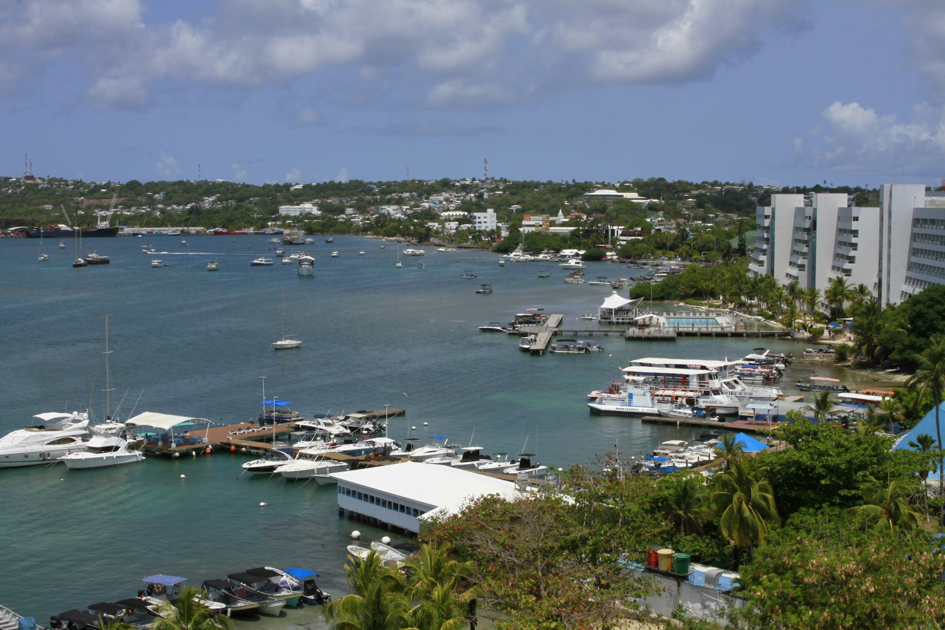 a harbor filled with lots of boats next to tall buildings