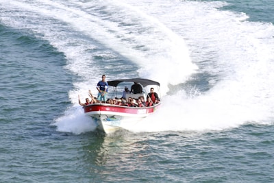 a group of people riding on the back of a boat