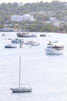 a group of boats floating on top of a large body of water