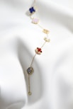 a close up of a necklace on a white cloth