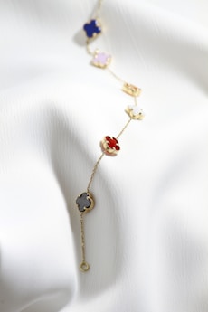a close up of a necklace on a white cloth