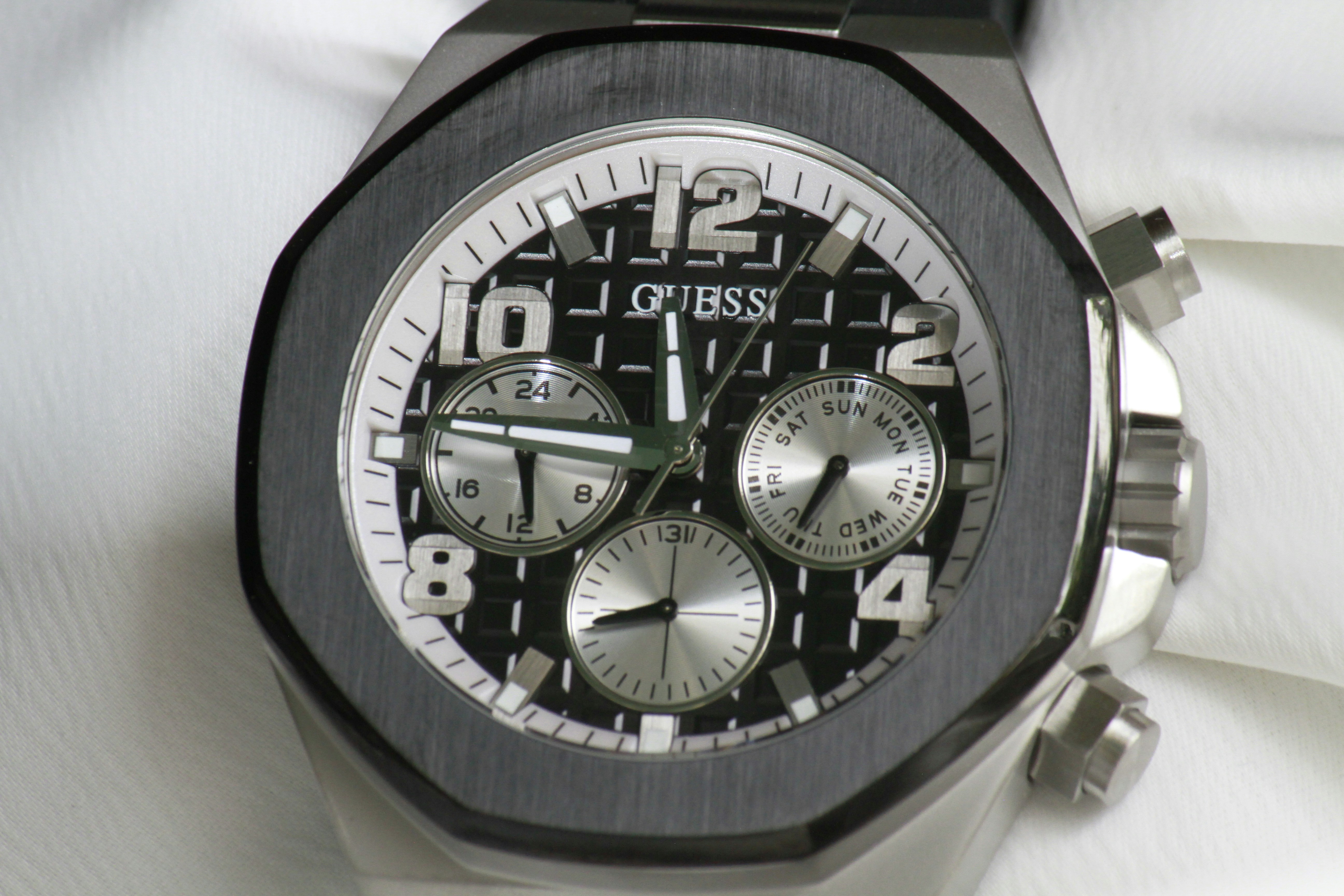 a close up of a watch on a white cloth