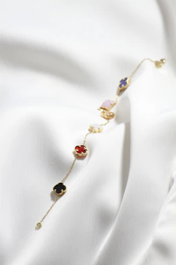a close up of a necklace on a white cloth