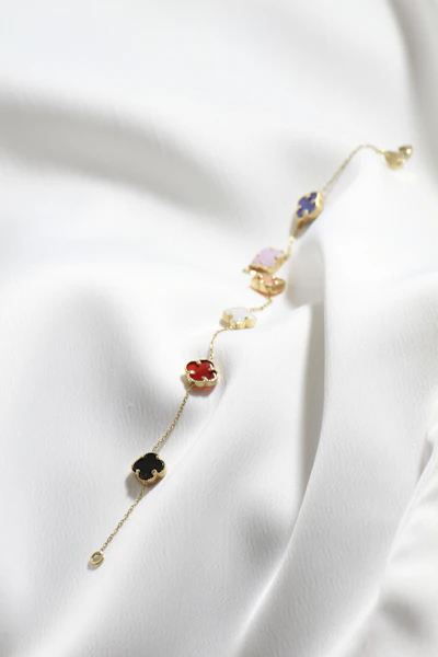 a close up of a necklace on a white cloth