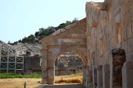 a stone building with an arch in the middle of it