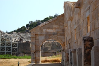 a stone building with an arch in the middle of it