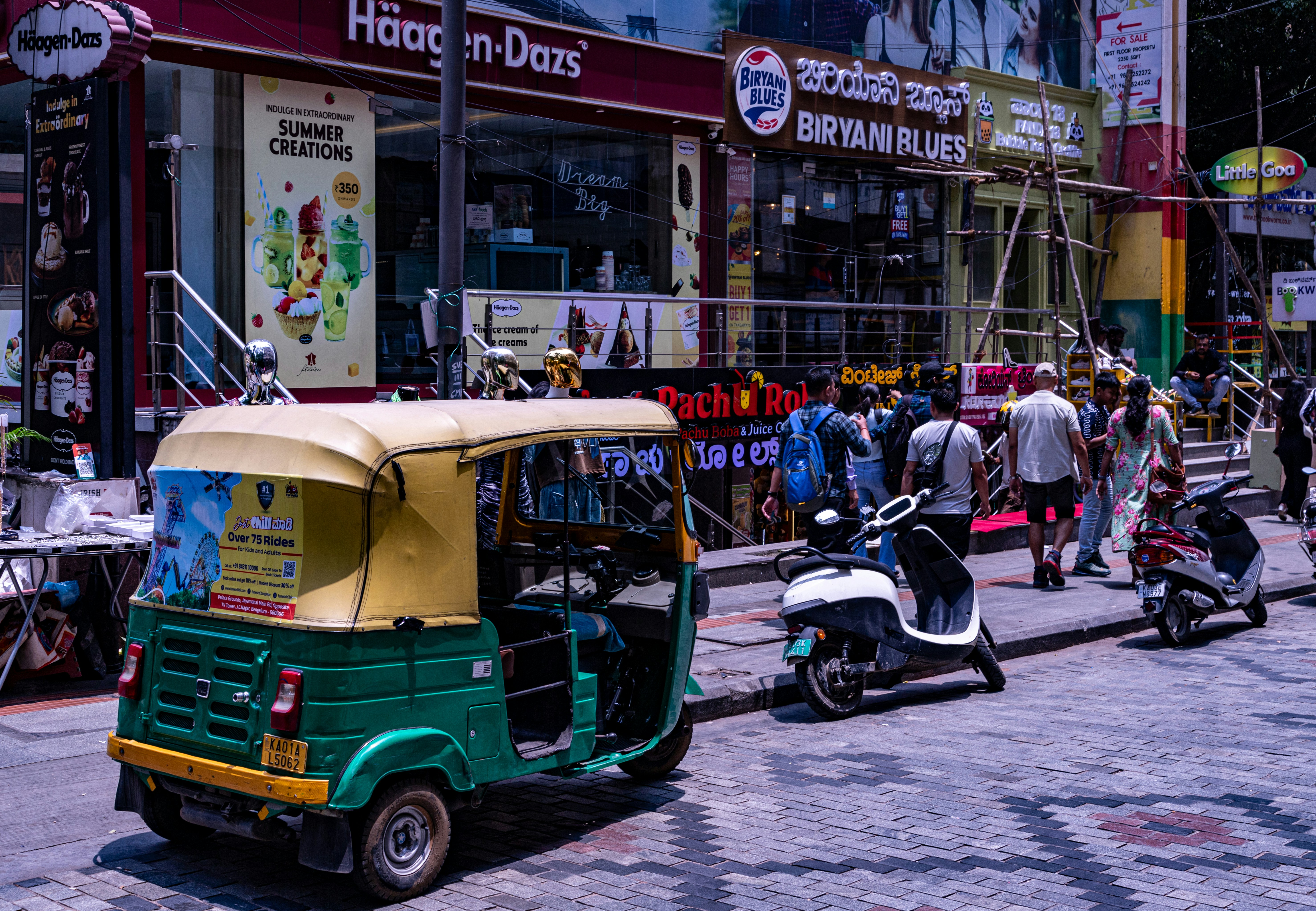 a tuk tuk parked on the side of a street