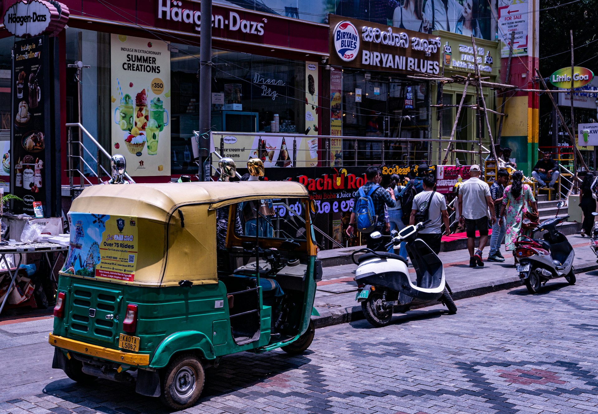 a tuk tuk parked on the side of a street