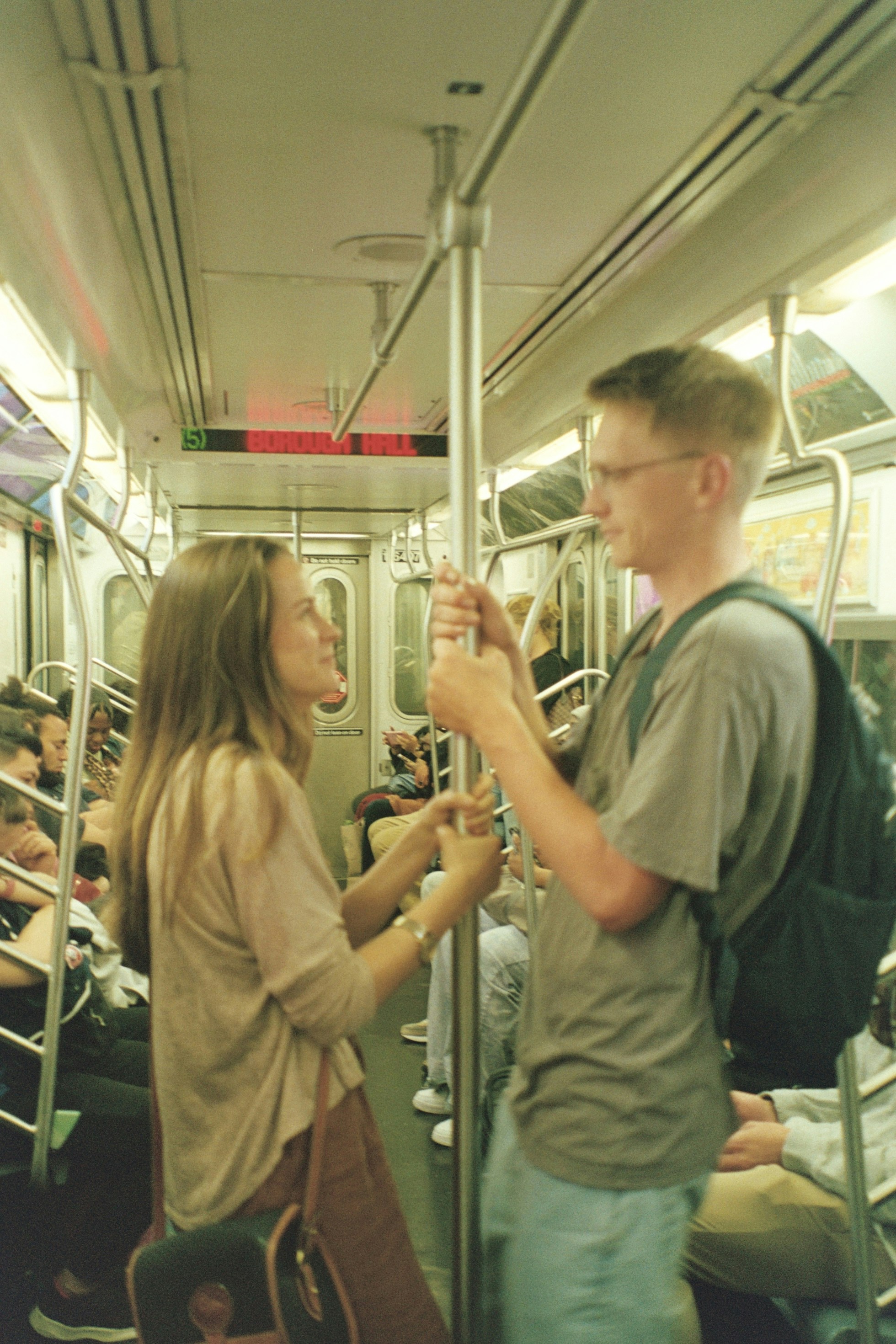 a man and a woman standing on a train
