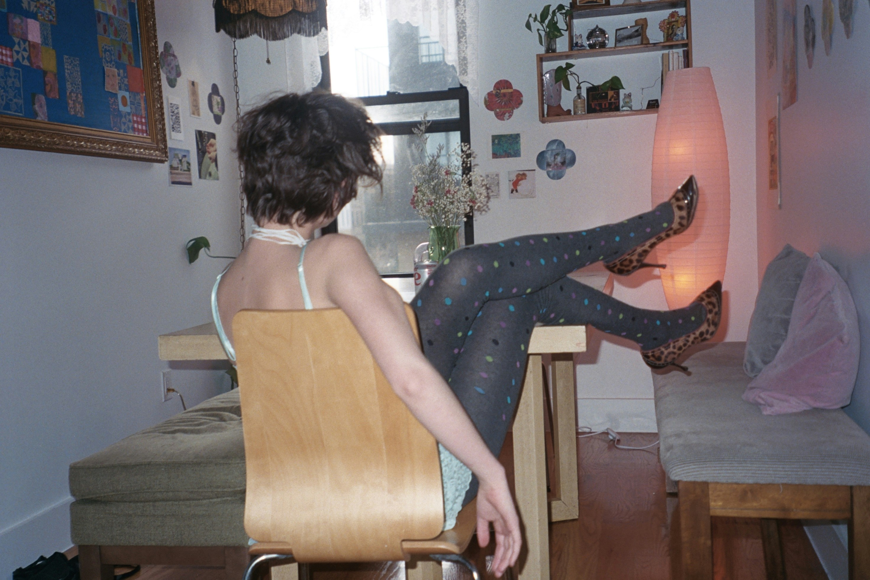 a woman sitting in a chair with her legs crossed