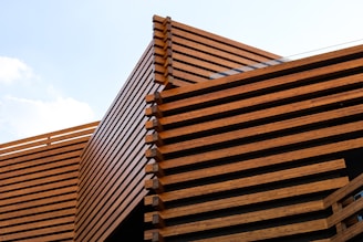 a building made of wooden slats against a blue sky