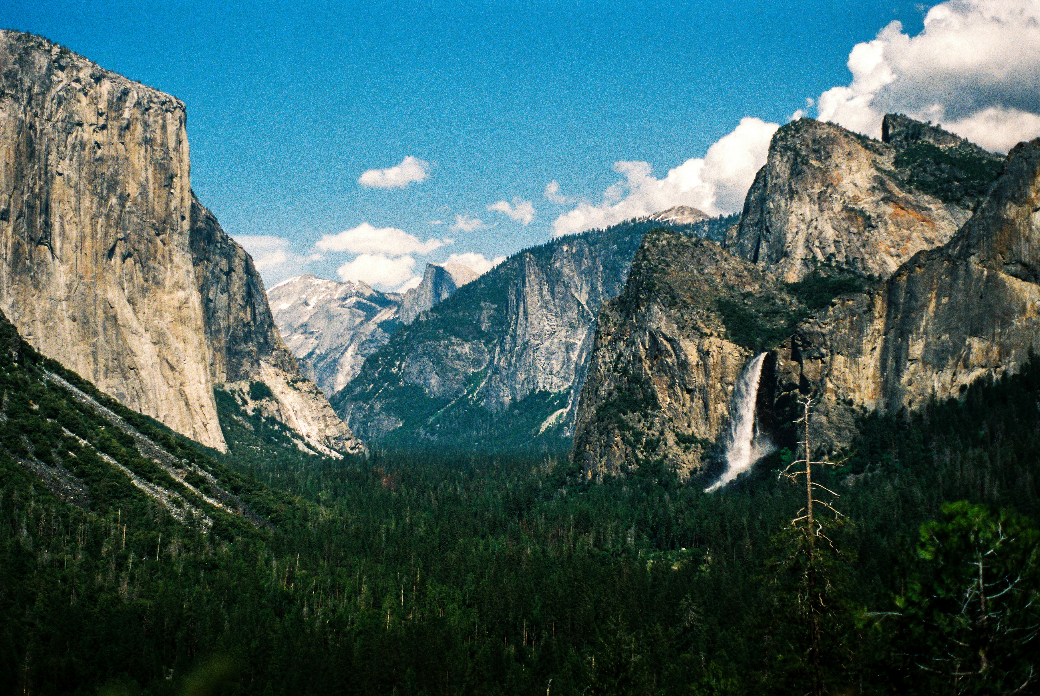 a mountain range with a waterfall in the distance