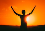 a person with their arms up in the air