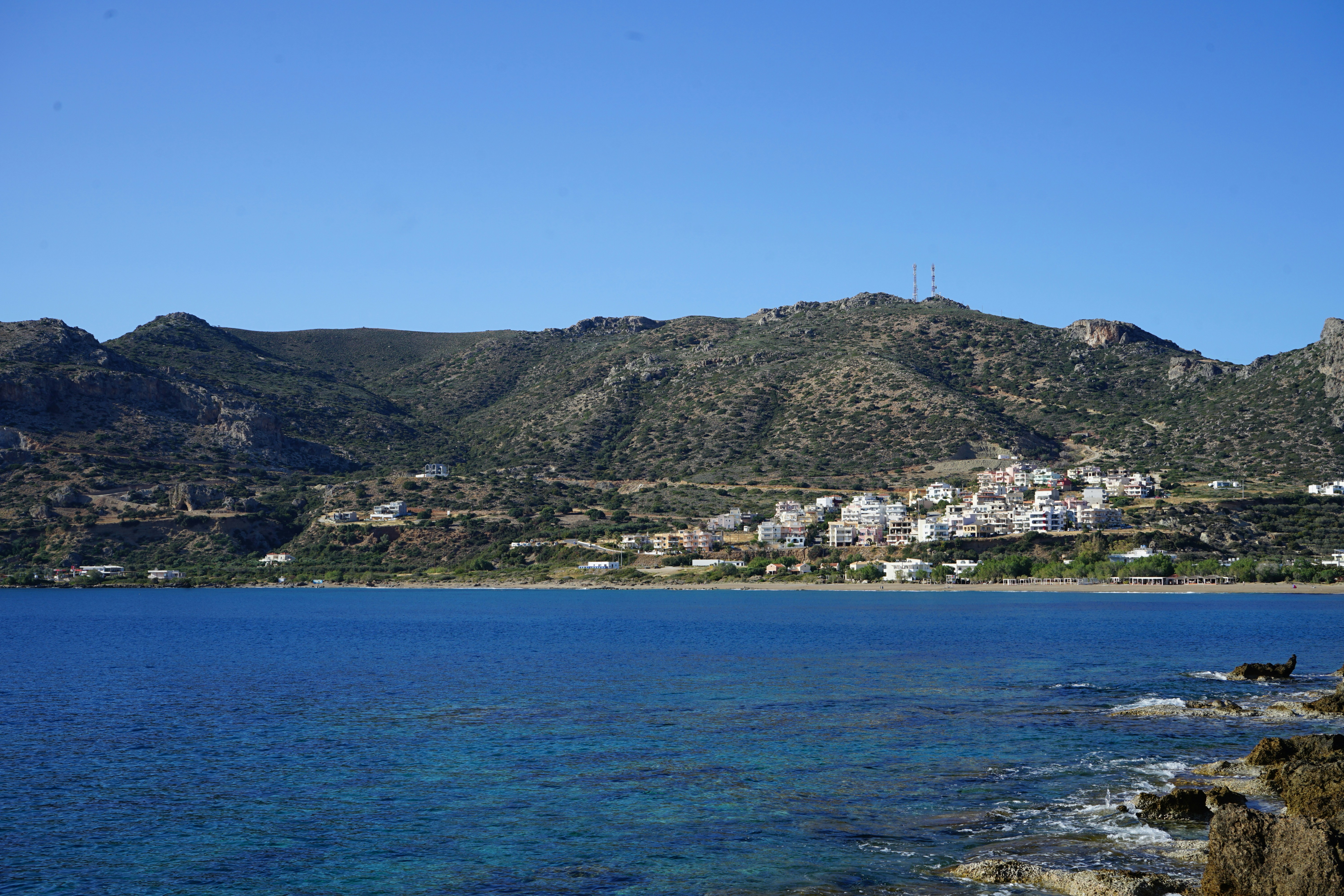 a body of water with a city in the background, Paleochora, Crete, Greece