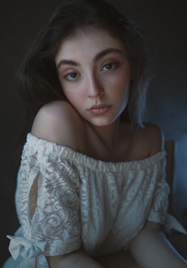 a woman in a white dress posing for a picture
