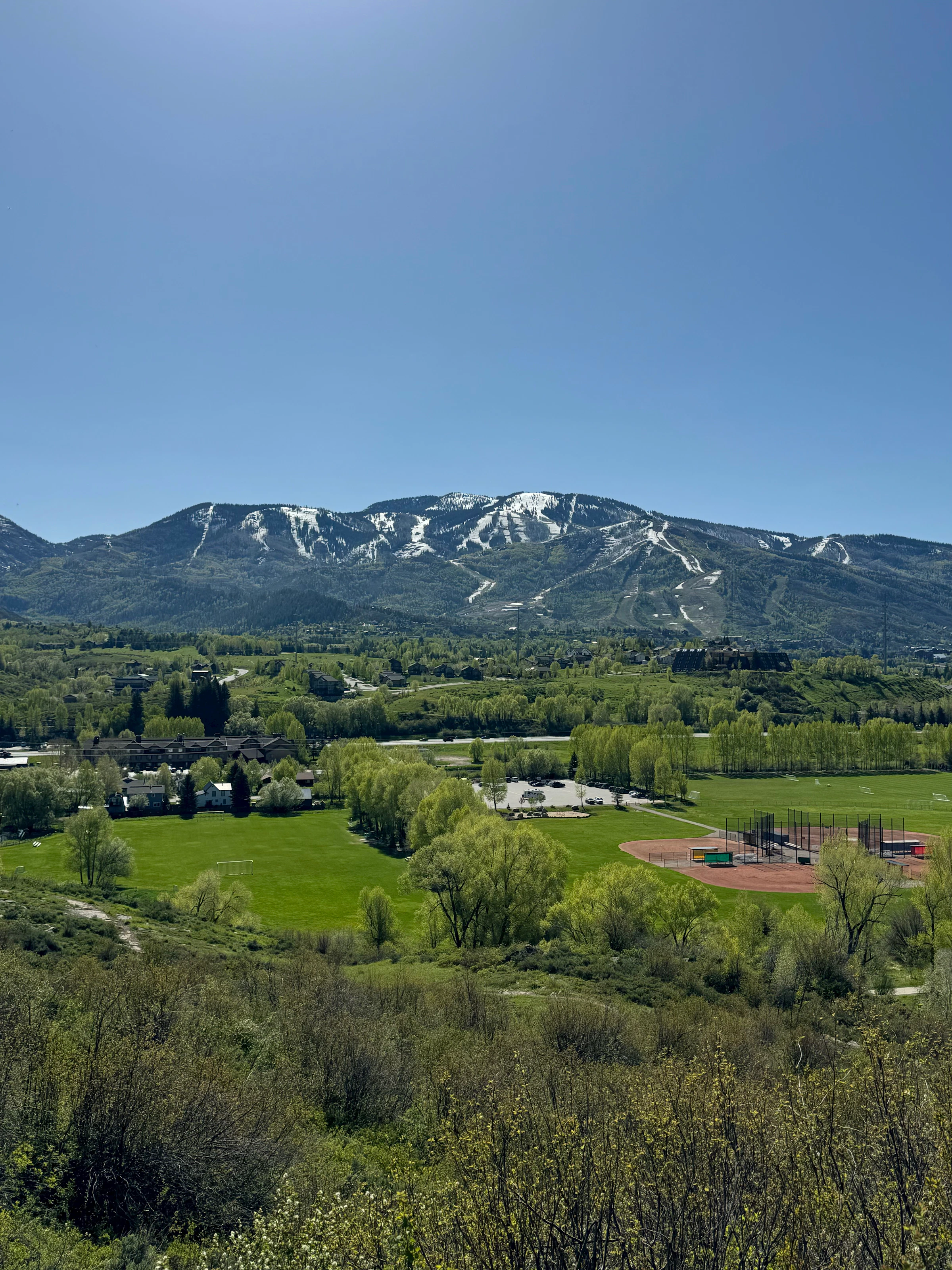Green Steamboat Springs valley with mountain backdrop