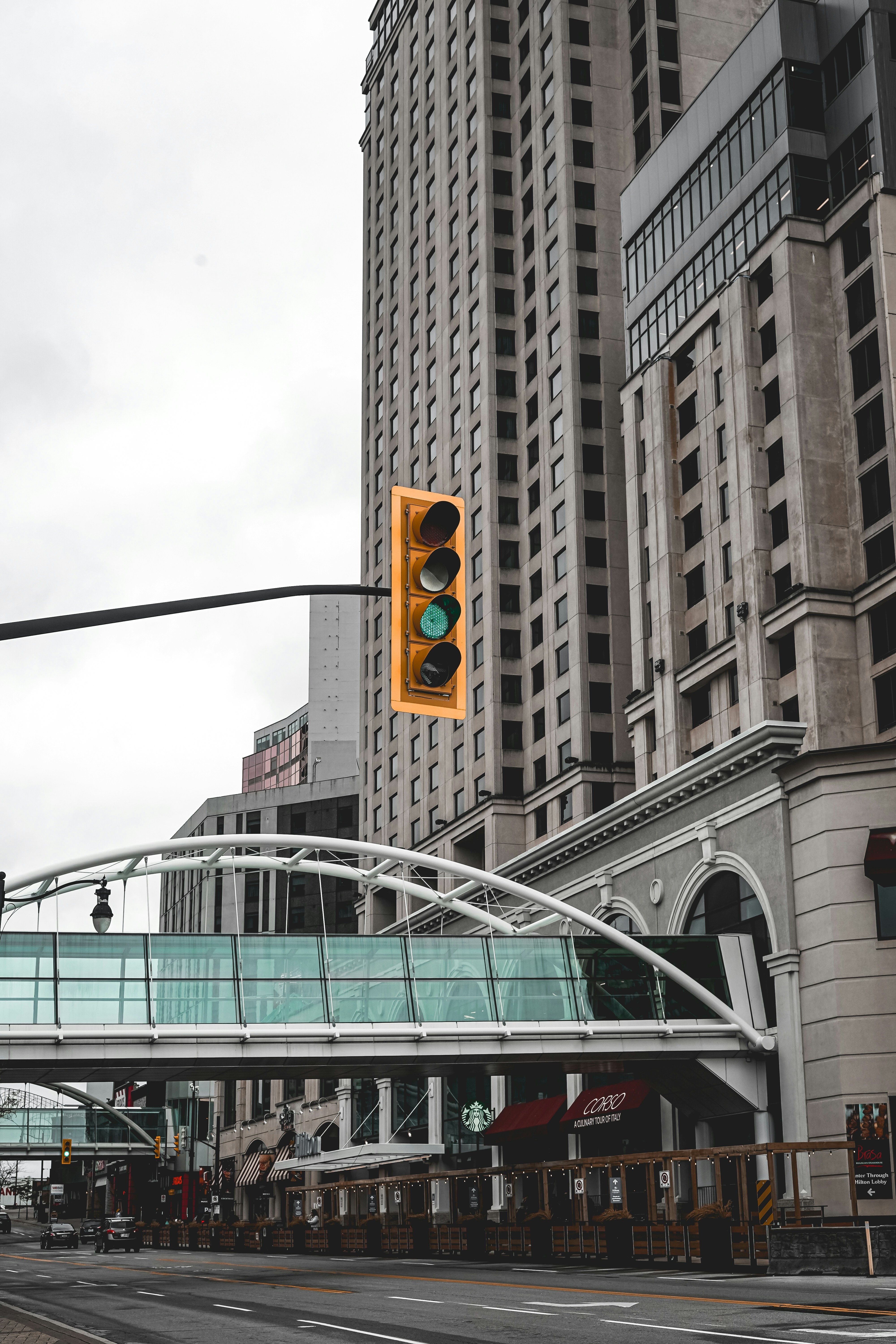 a traffic light hanging over a street next to tall buildings