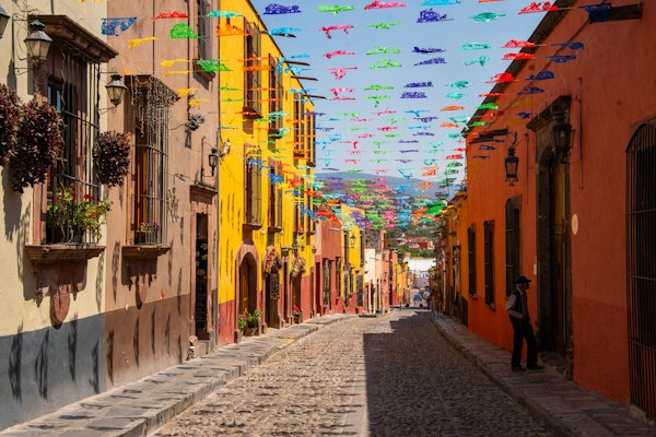 A cobblestone street lined with colorful flags — San Miguel de Allende, Mexico