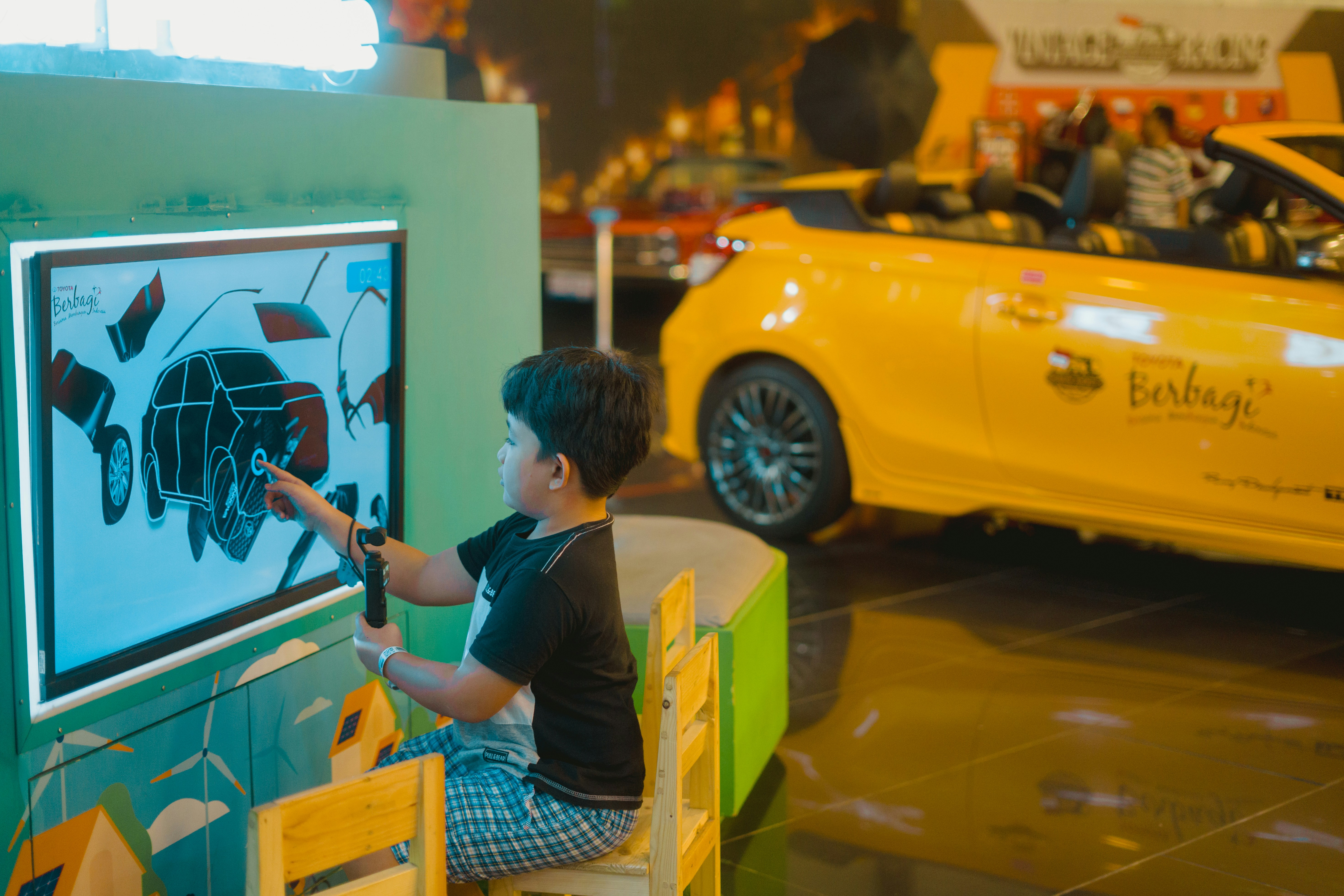 Family comparing a new electric car in a bright dealership showroom