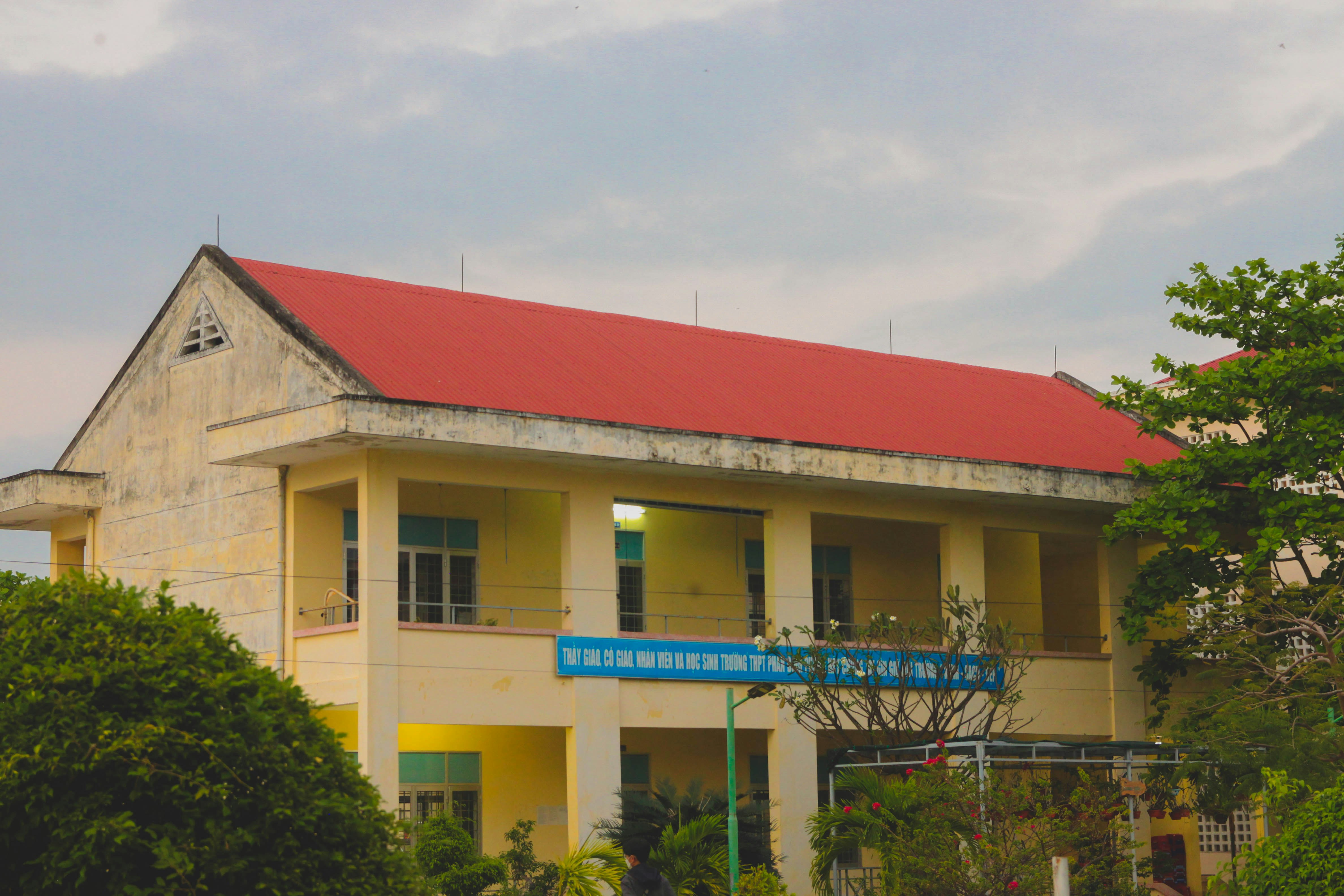 a yellow and red building with a red roof