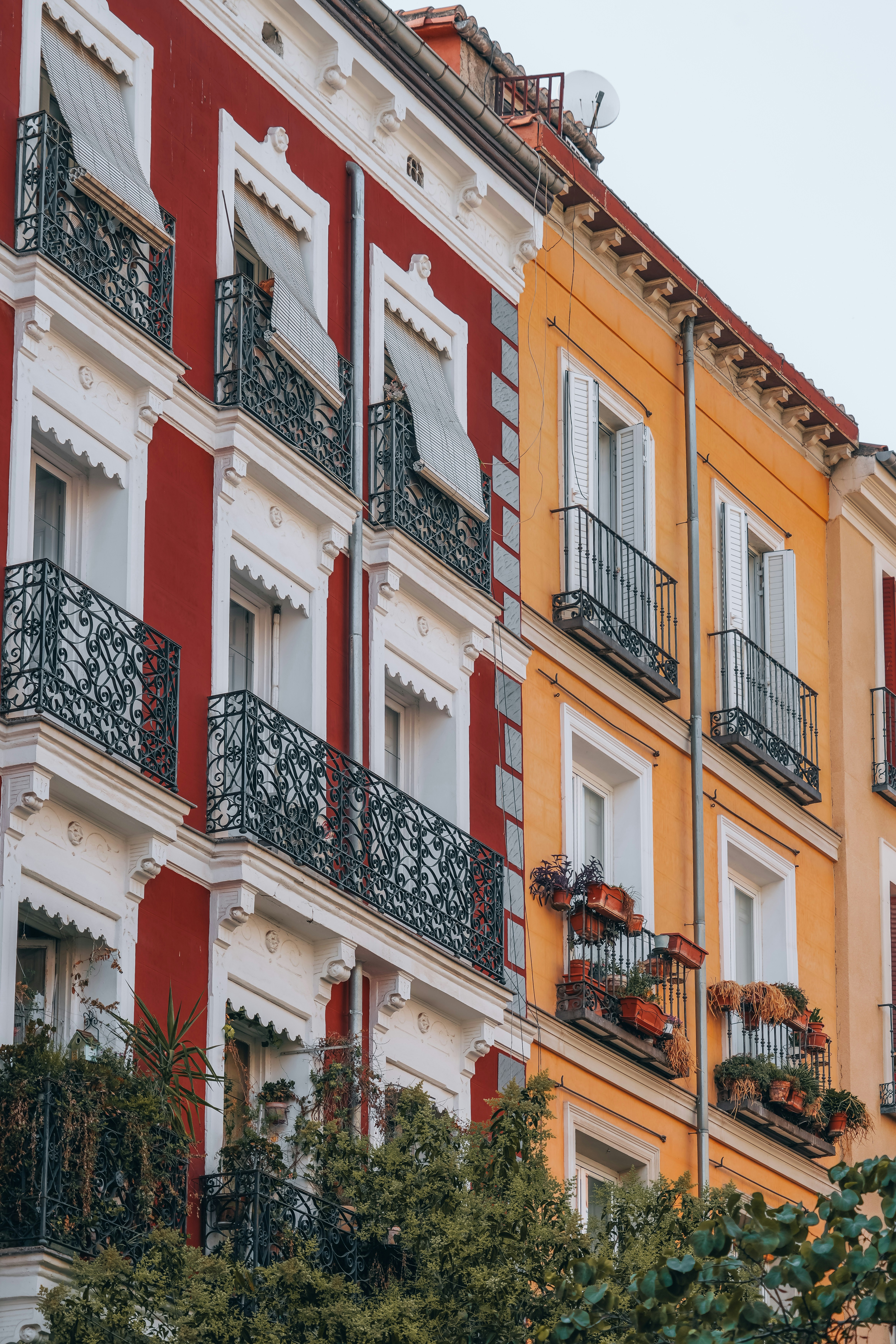 a red and white building with balconies and windows